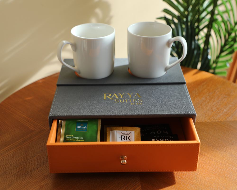 Rayya Suites branded tea and coffee welcome tray with two mugs